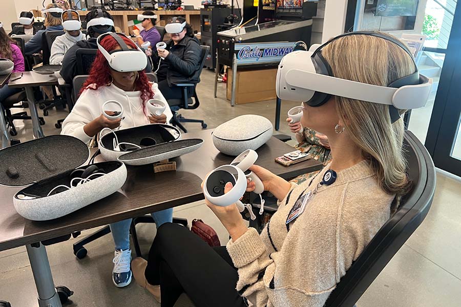 Two women wearing and working with vr headsets