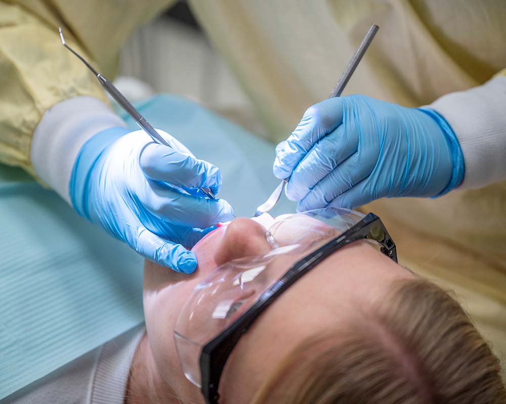 Student Working on Patient