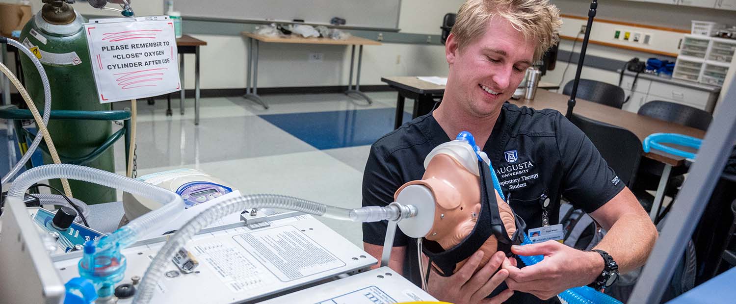 Student working with respiratory machine 