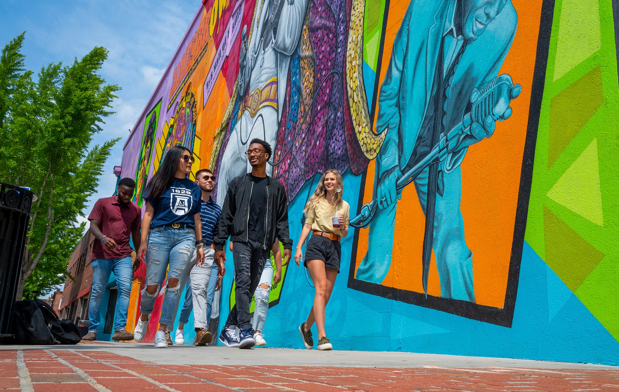 Students walking in front of mural in downtown Augusta