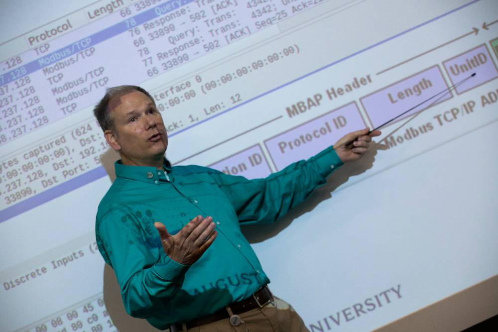 professor pointing at board 