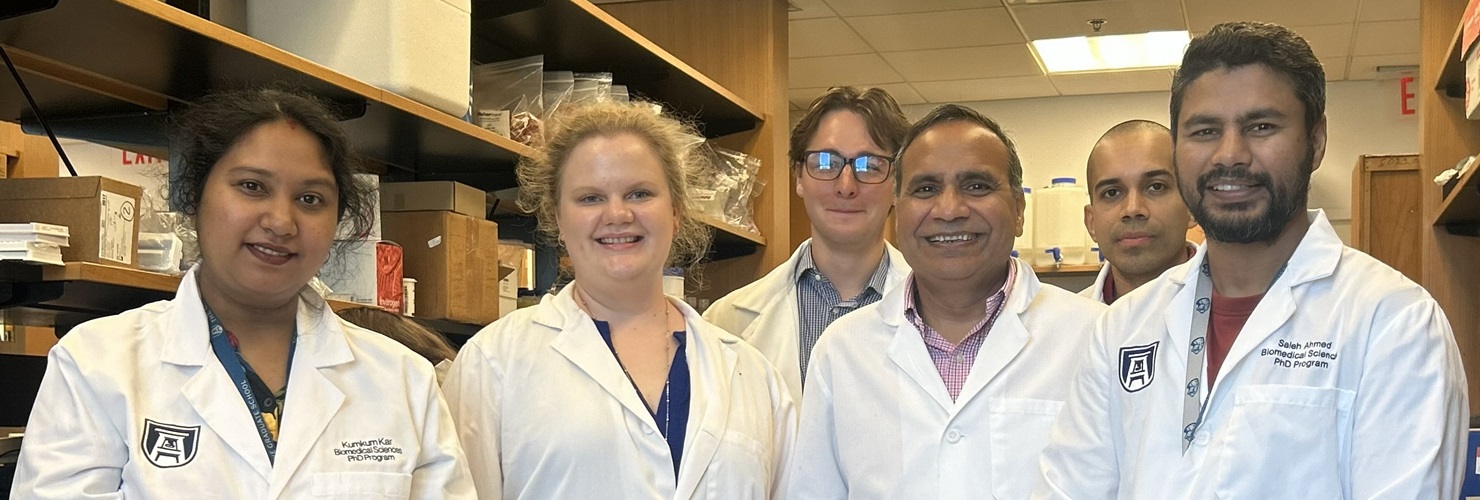 Dr. Ashok Sharma's lab team pose for photo in lab