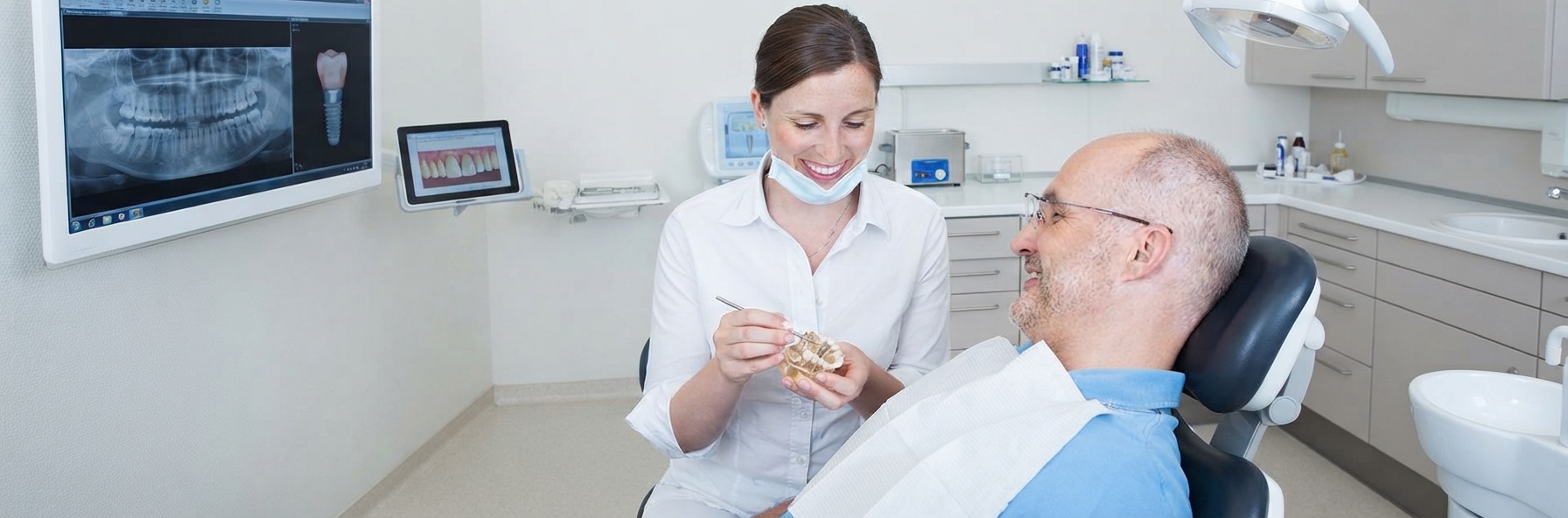 Female staff member with male dental patient