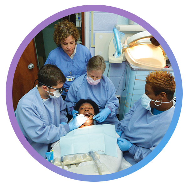Patient recieving dental care from a team of providers at DCG