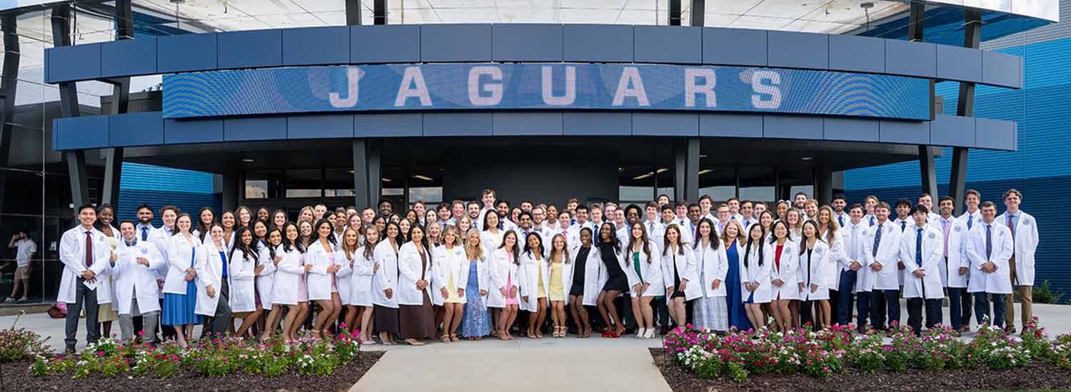 group shot of dental college students in white coats