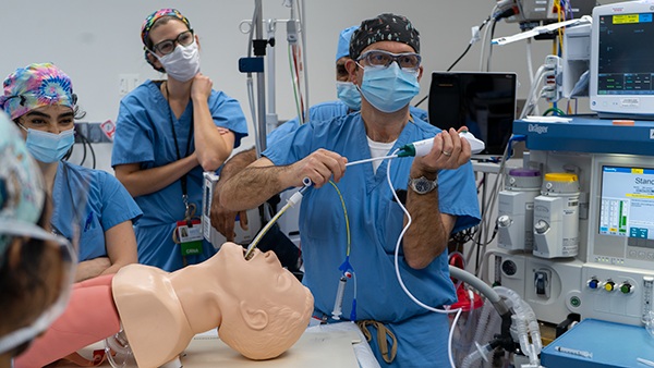 Physician teaching student through educational simulation