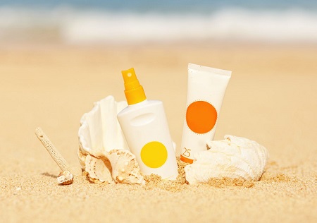 sunscreen positioned for photo in sand