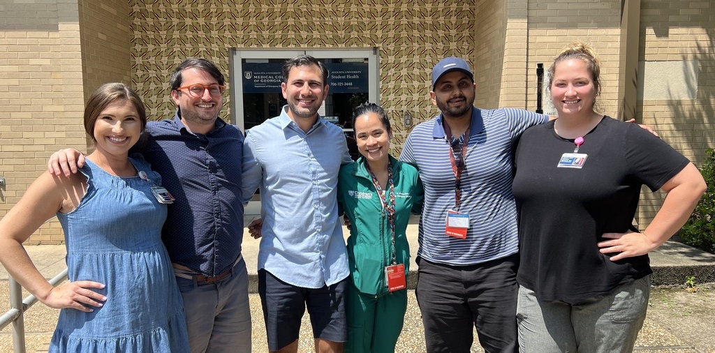 PEM fellows smiling at camera