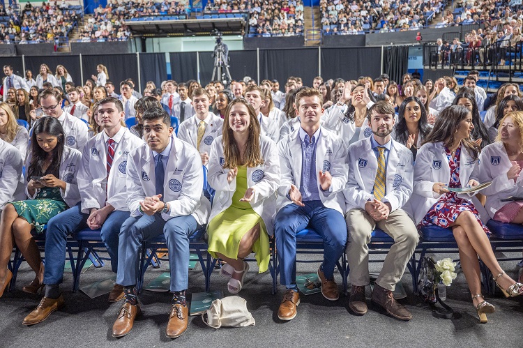 Group of young adults sitting at White Coat Class of 2027