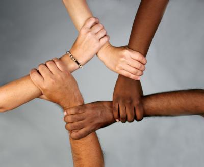 hands of different ethnicities connecting to make a visual of a star