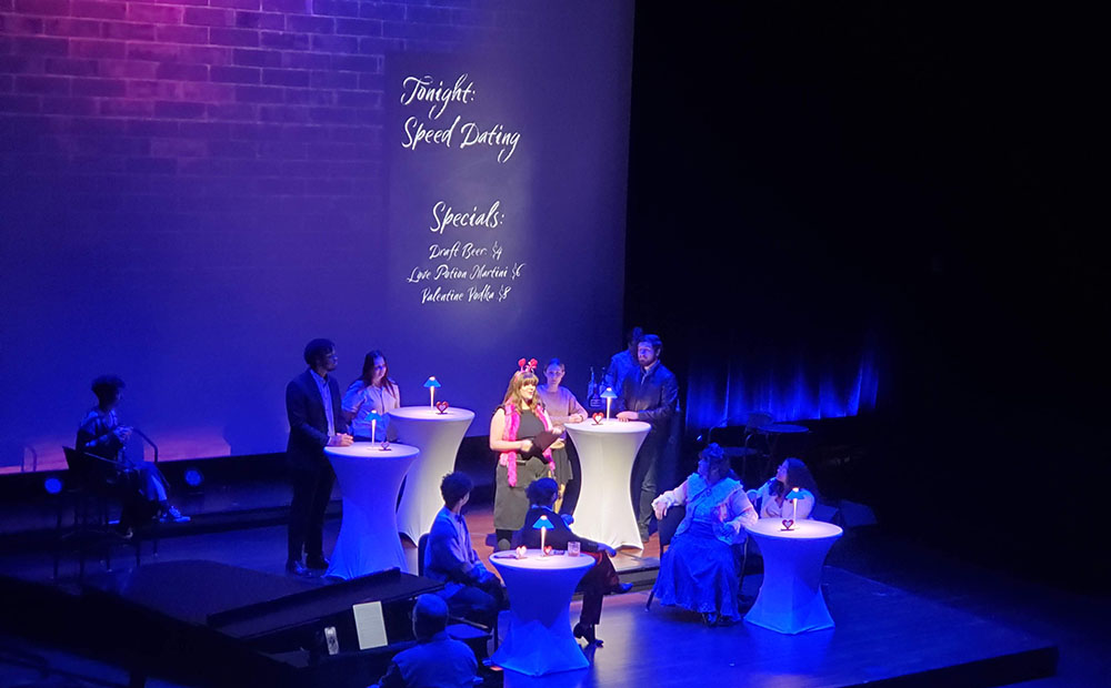 Performance on stage with characters at tables