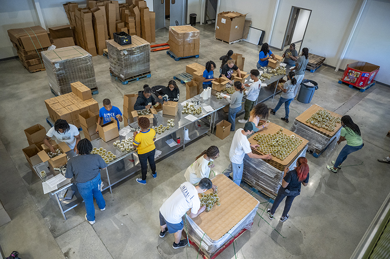 Students team up at Golden Harvest to pack food-making a difference, one meal at a time!