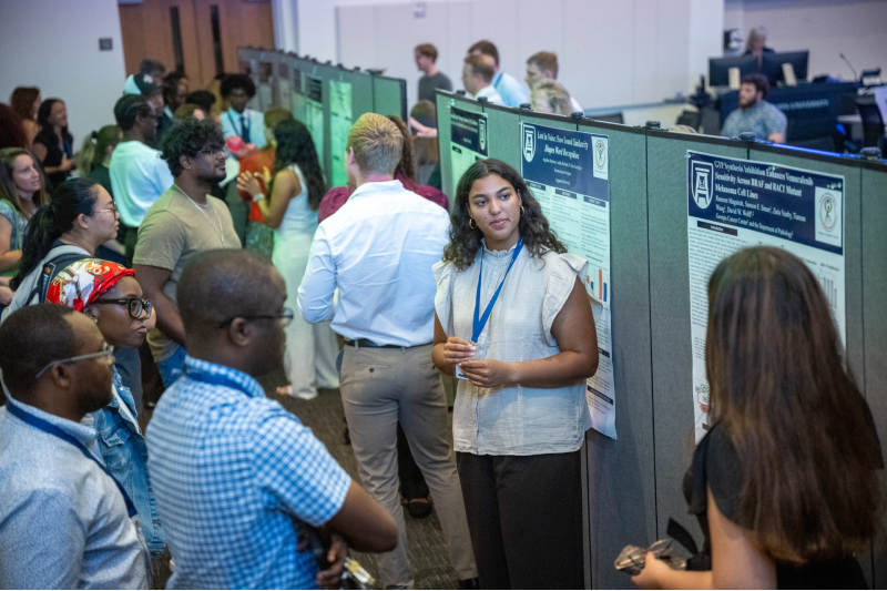 group of students standing around posters