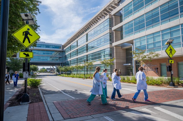 students walking in front of cancer center building