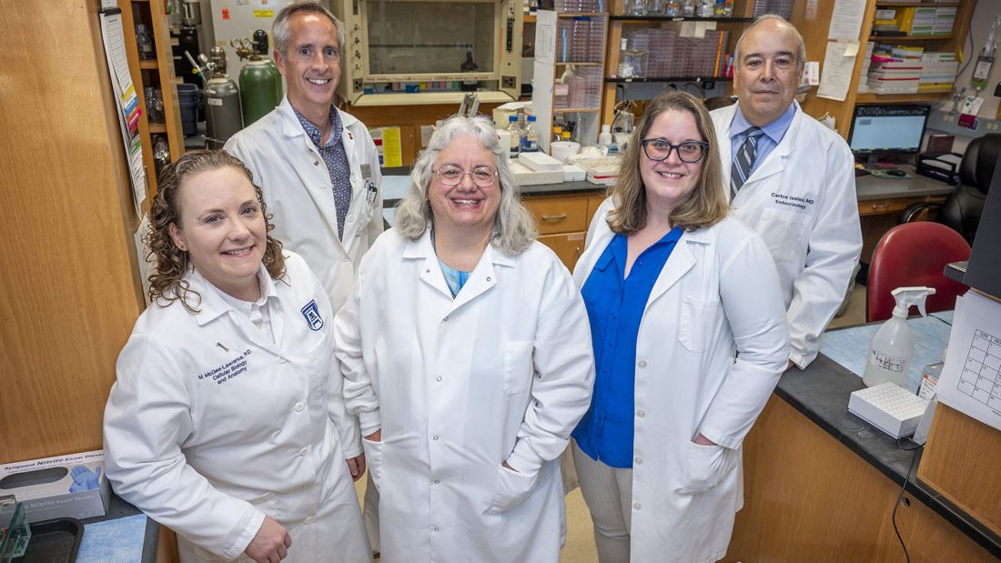 photo of four researchers in white coats