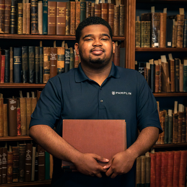 Charles Boyd in front of old bookcases