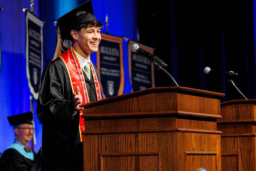 man speaking at podium