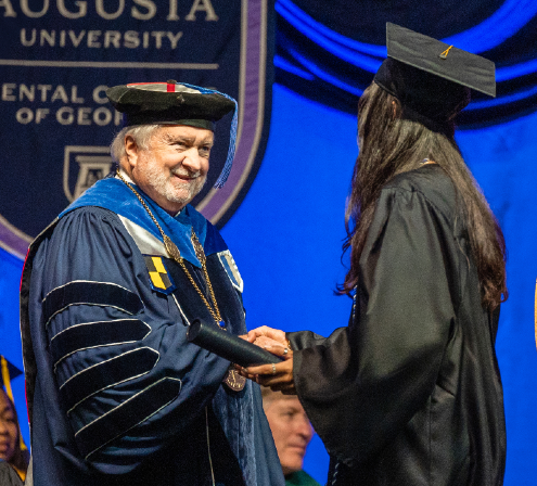 President Keel shakes student's hand at commencement 