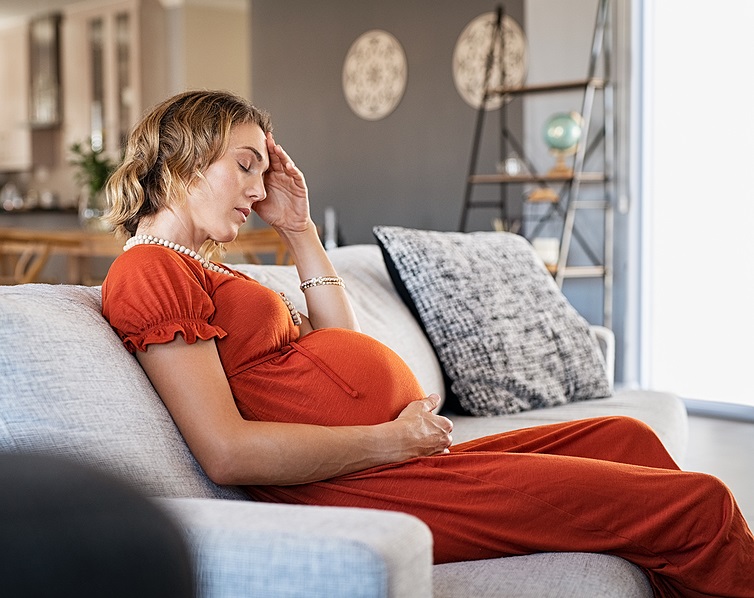 Exhausted, worried pregnant mother