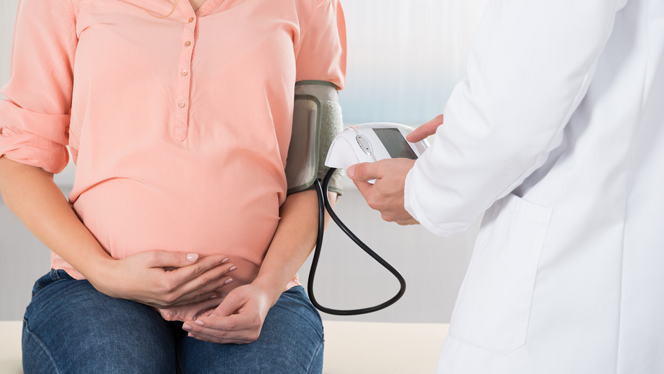 Pregnant woman getting bp taken