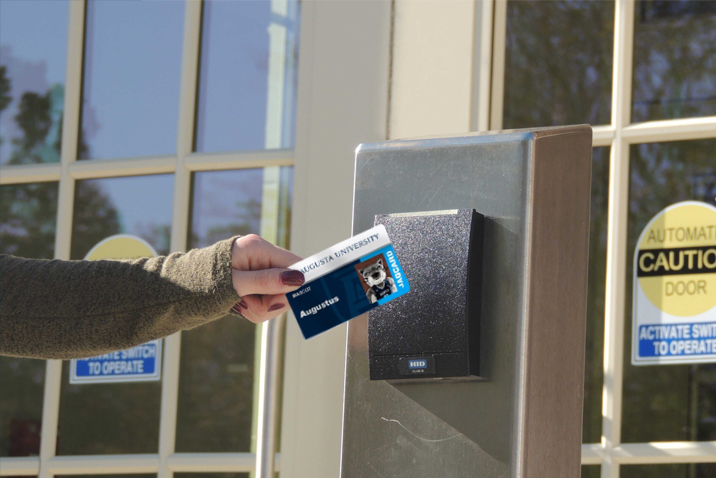 ID card being used to open door to building