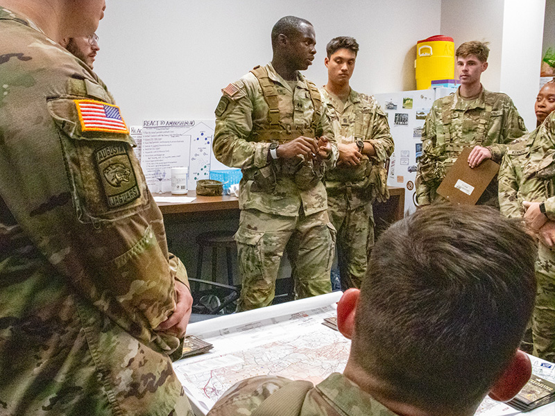 Cadets in classroom in front of map getting a brief