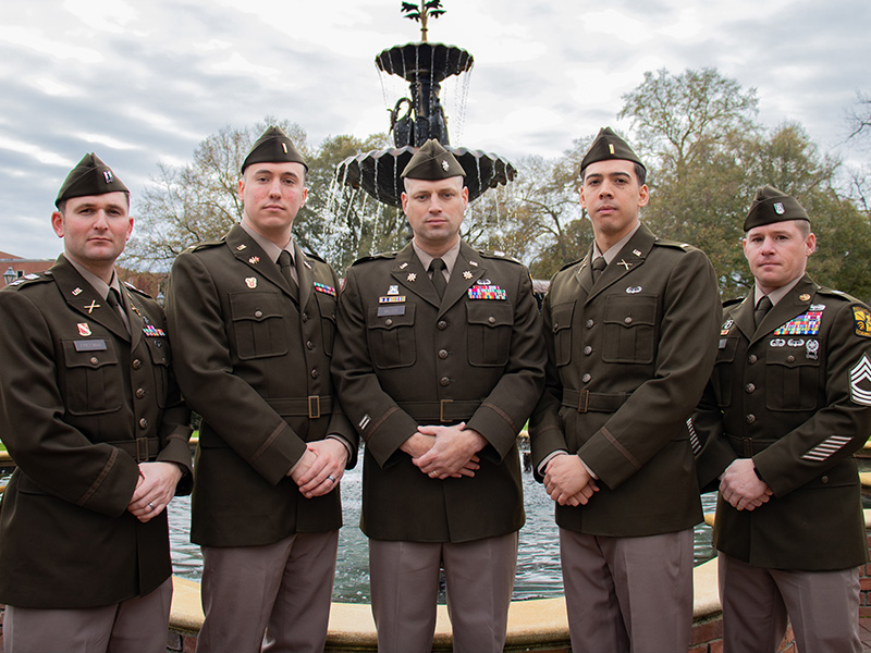 Cadre and 2 LTs stand in front of AU fountain