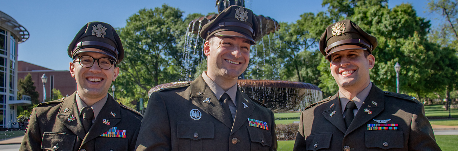 3 newly graduated 2nd Lieutenants stand in front of AU Fountain