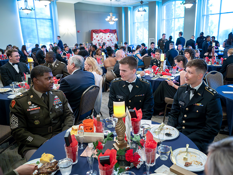 Cadets speak to guest speaker at military ball