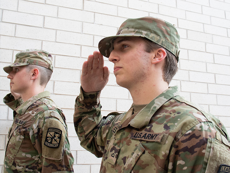 Cadet salutes in uniform