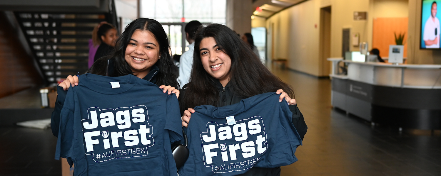 students holding up #JagsFirst t-shirts