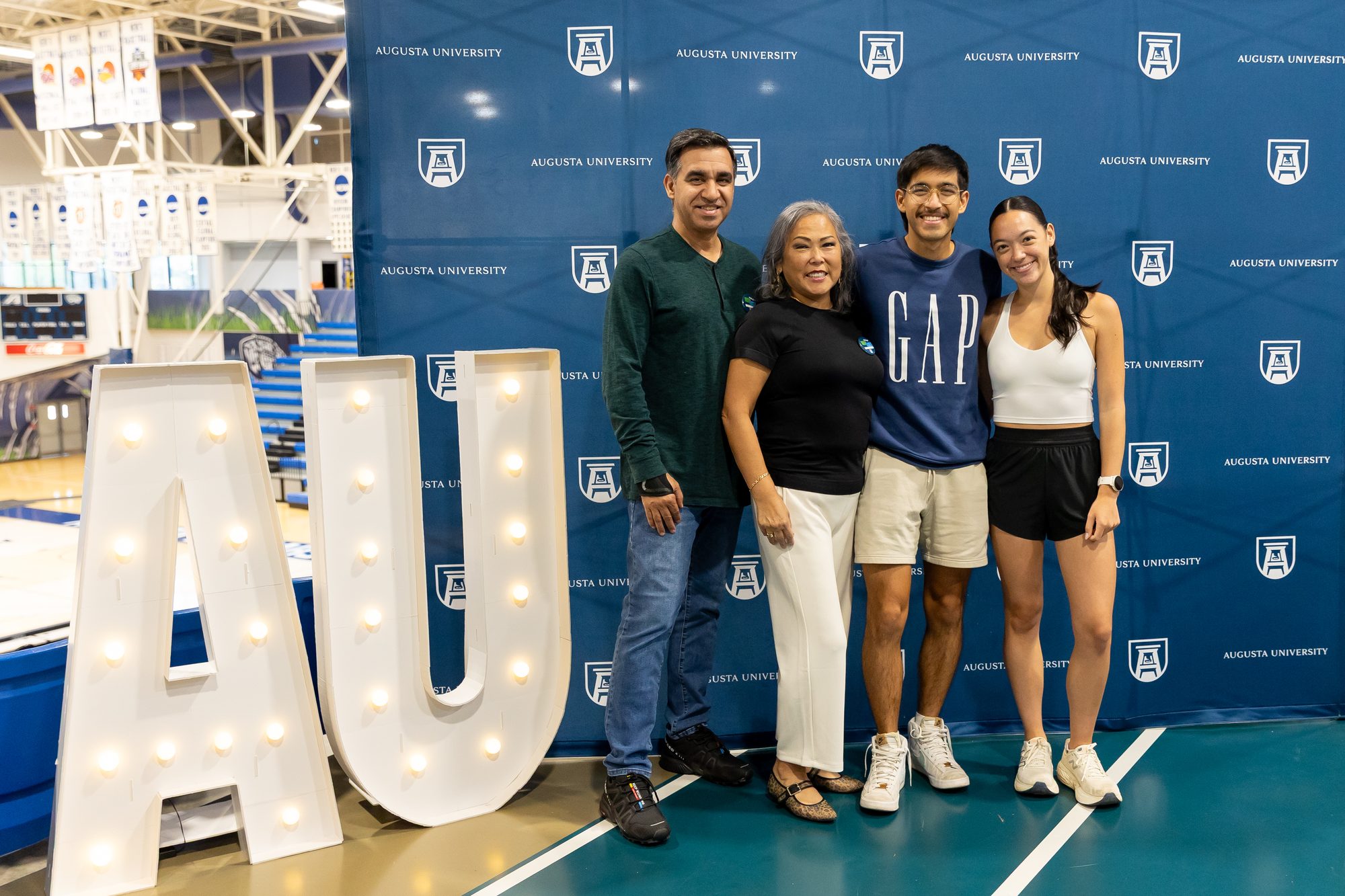 Family members smile together at an Augusta University event.