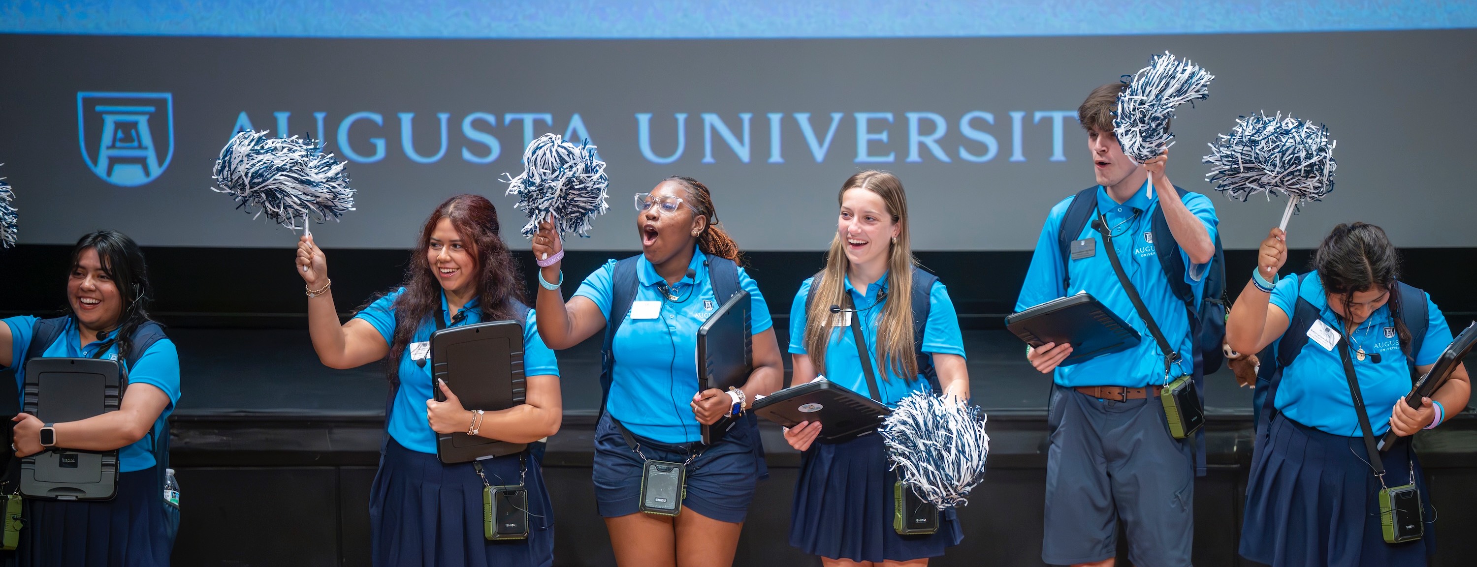Photo of orientation leaders on stage during new student orientation