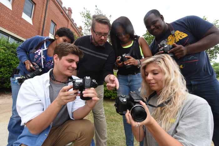 group of students looking at cameras