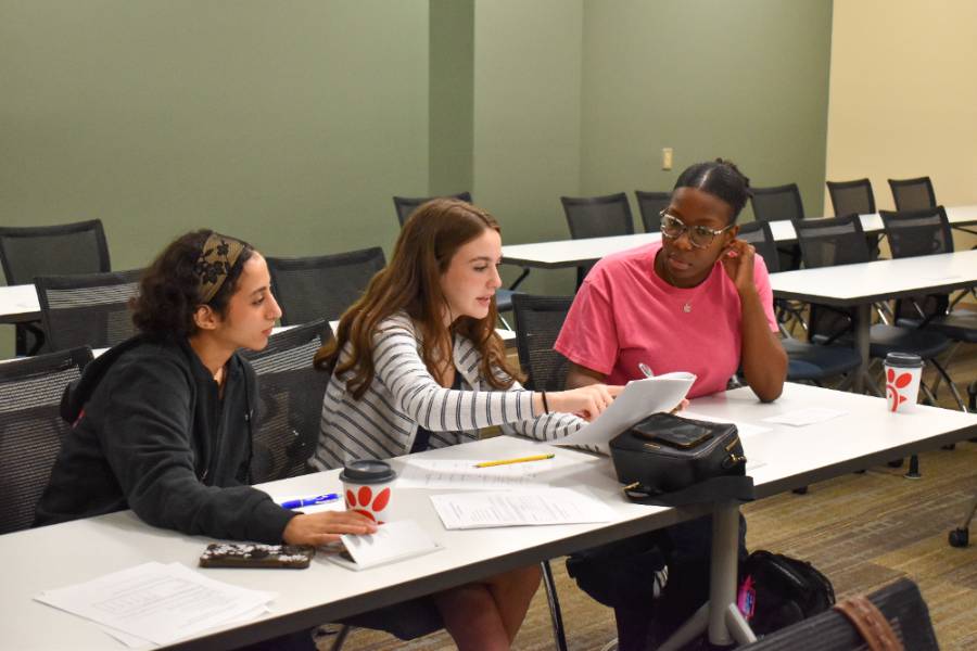 three female students sitting next to each other