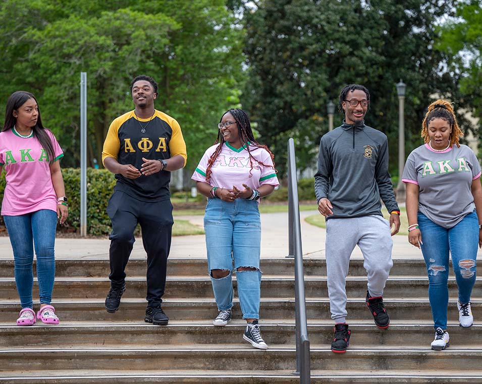 Multiple Students walking down steps