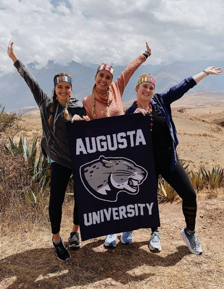 three girls holding a flag