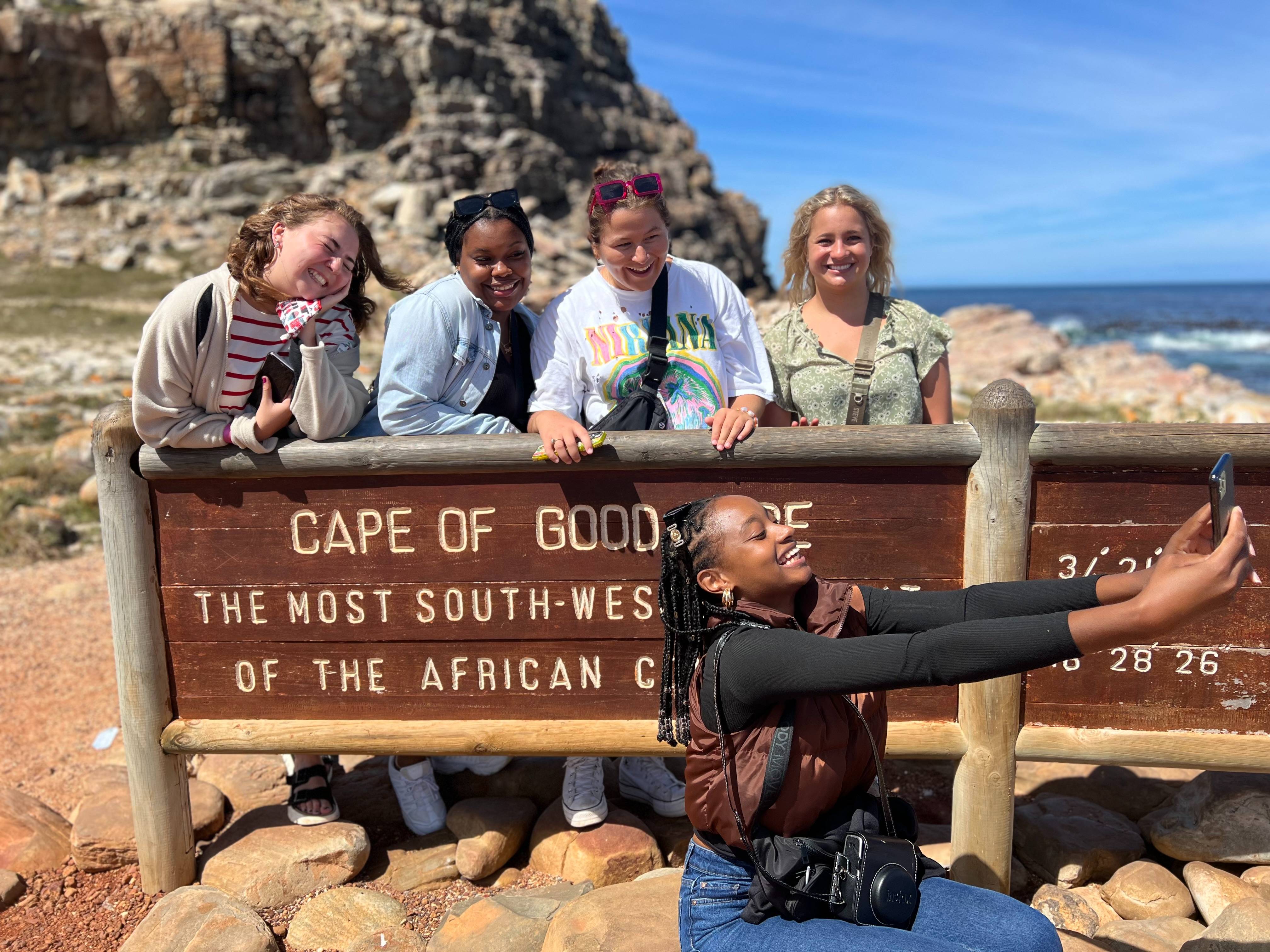 group takes selfie on mountain side