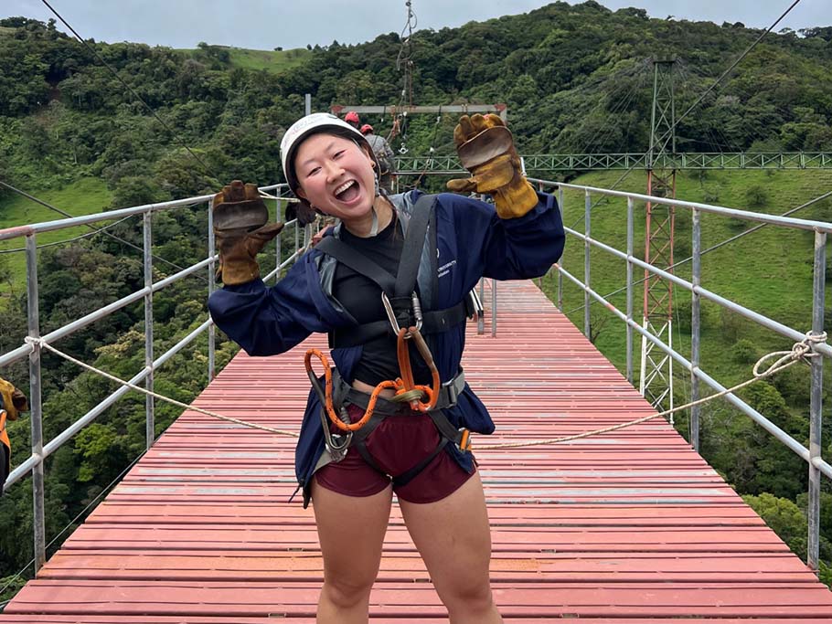 woman in hard hat on bridge