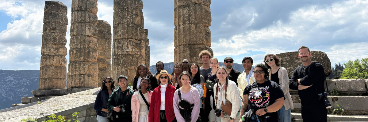 A group of students in front of ruins in Greece.