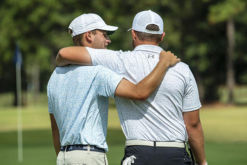 Two golfers provide moral support on the green